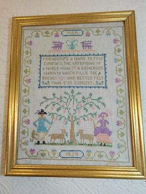 The Vintage 1929 Framed Friendship Folk Art Cross Stitch Sampler is a unique and